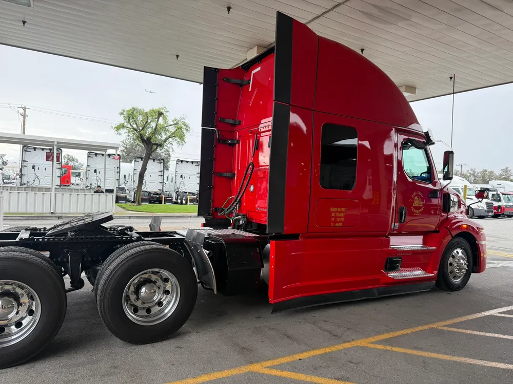 Fire Chief Transport's red Western Star tractor parked at a fuel stop