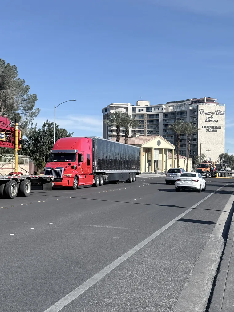 Red truck driving a city street