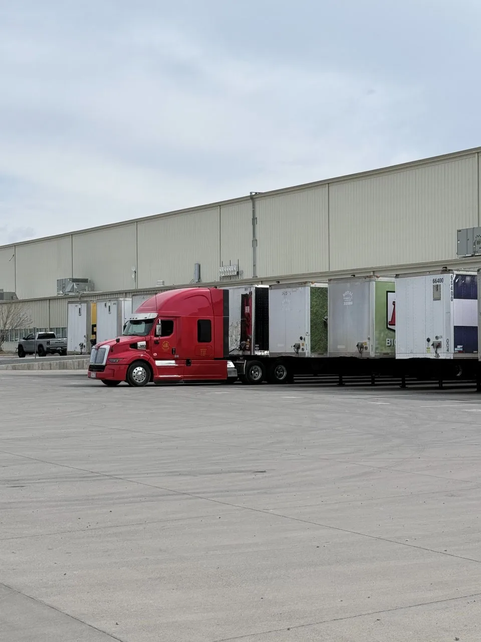 Red truck at a warehouse dock