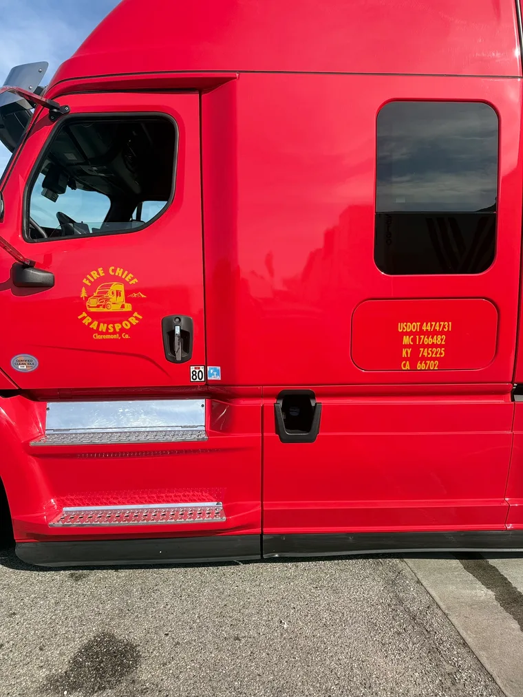 Sleeper-side logo and DOT numbers on the truck
